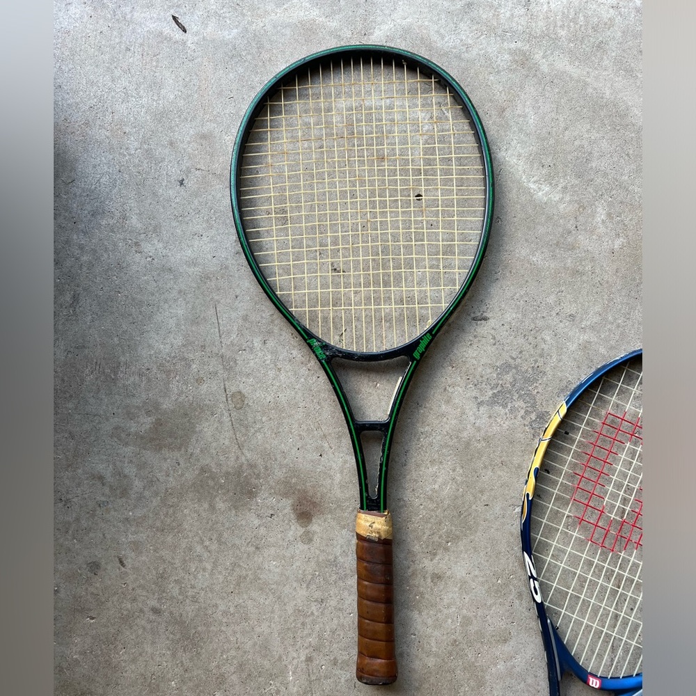 Vintage Prince Graphite Tennis Racquet
W/4-1/2" Leather Wrapped Grip